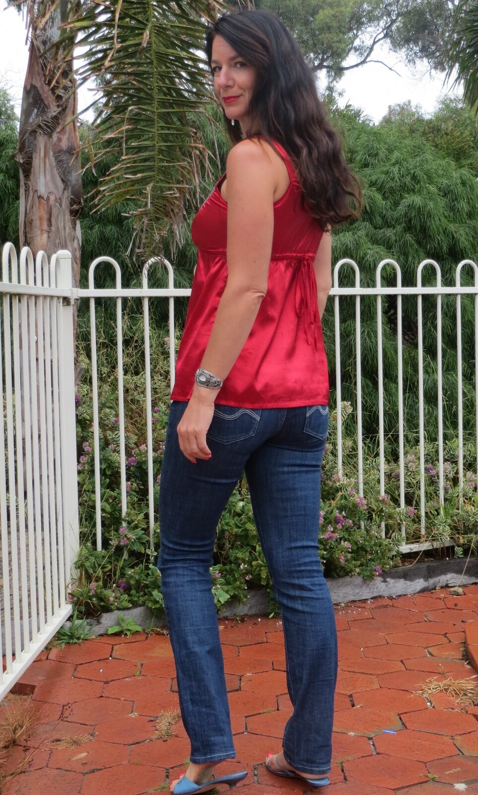 Red silk top, jeans behind