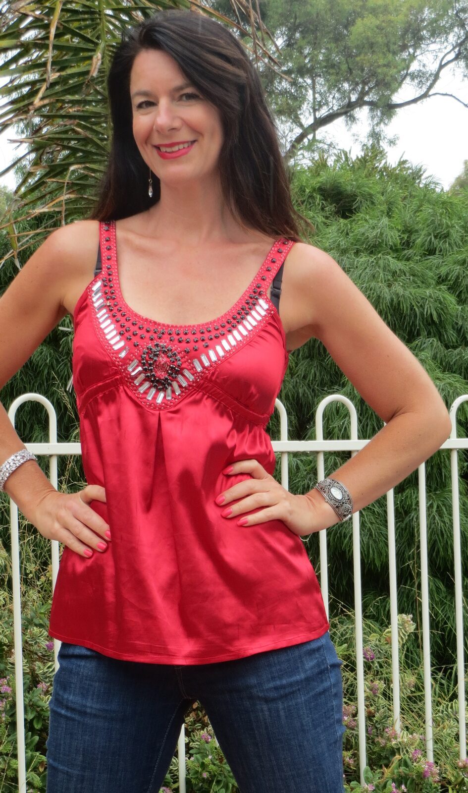 Red silk top, jeans close-up