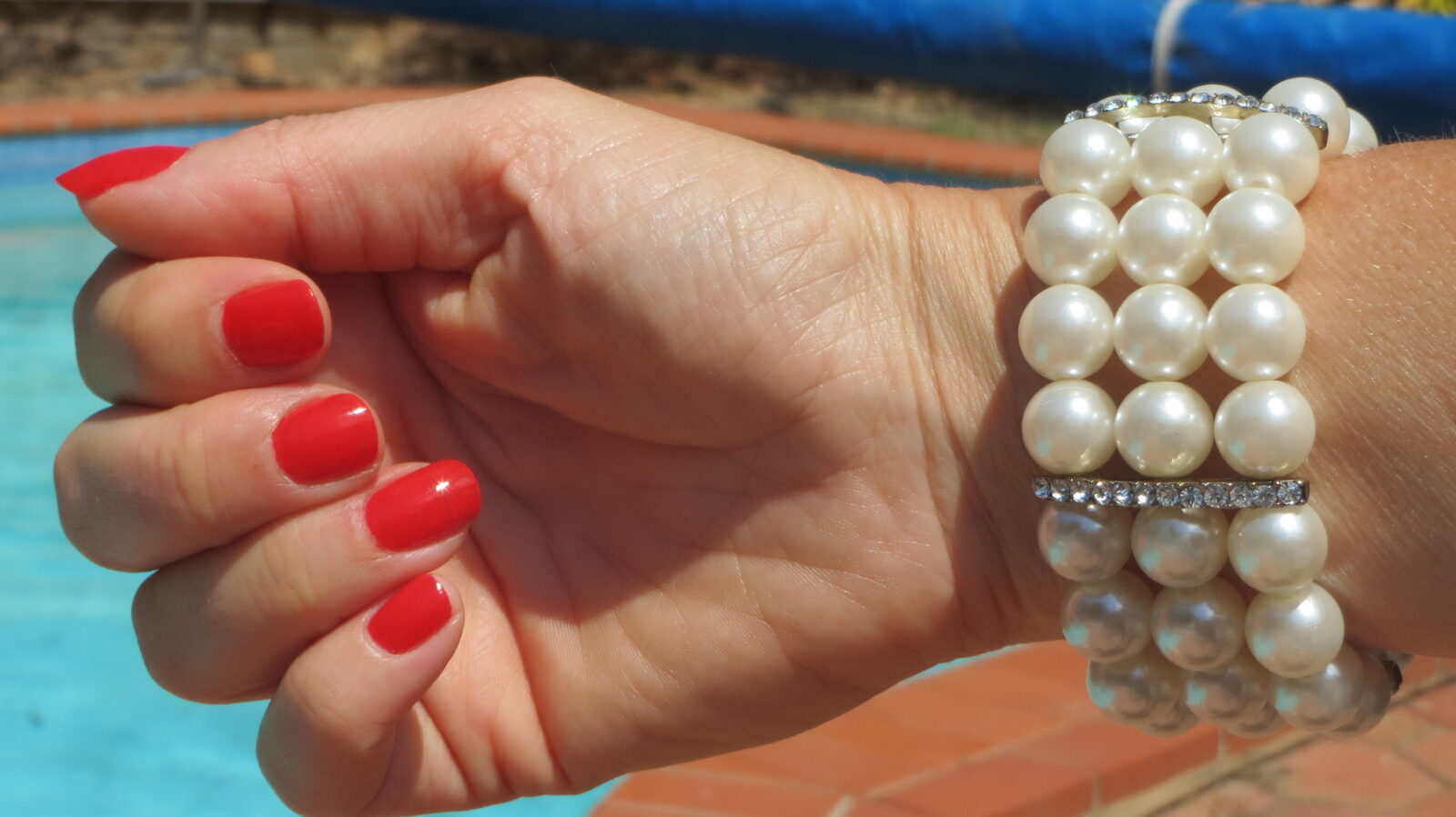 Pearl cuff, red nails