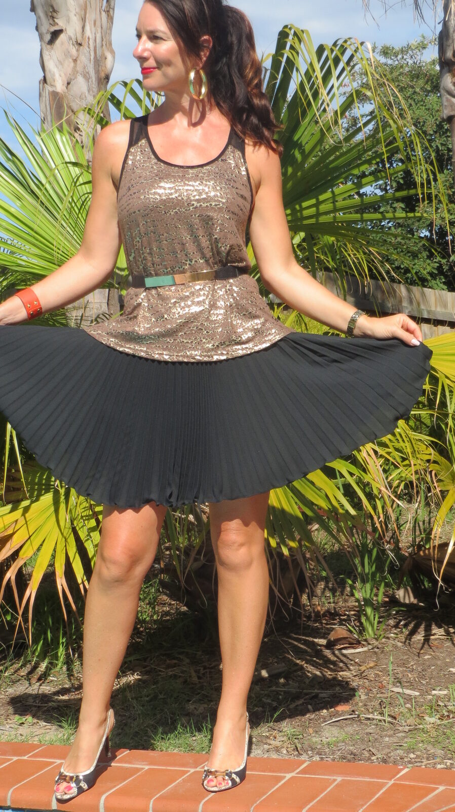 Gold singlet, black pleated skirt 1