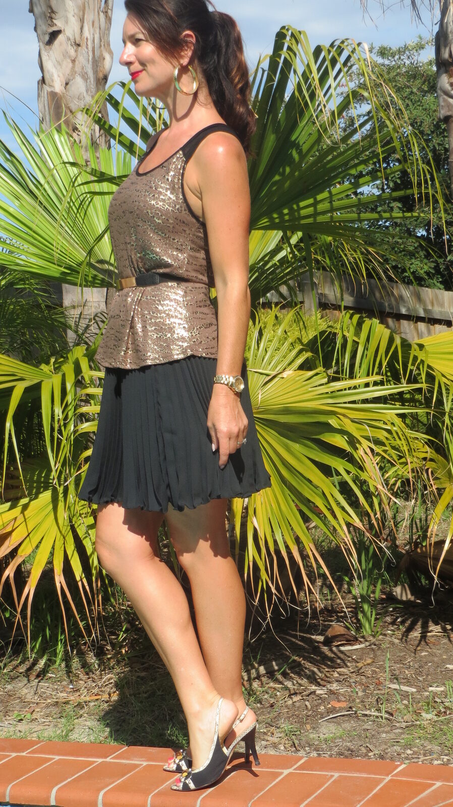Gold singlet, black pleated skirt 3