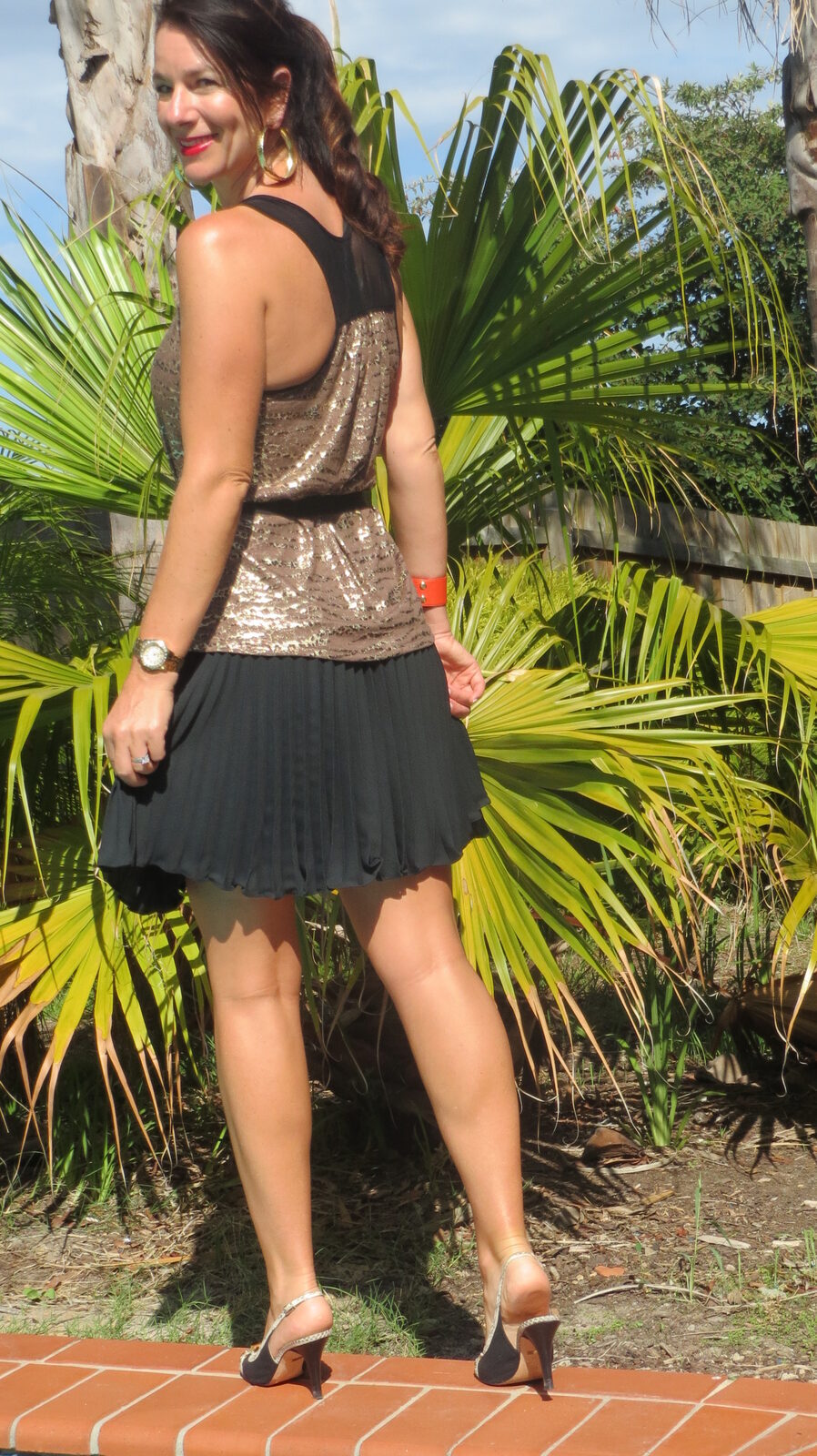 Gold singlet, black pleated skirt 5
