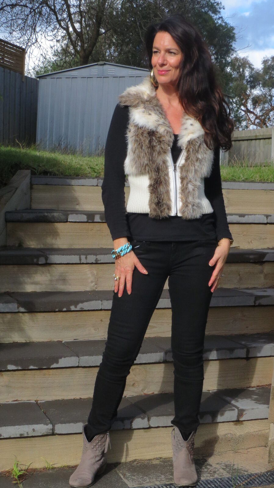 Black jeans, fur vest 1